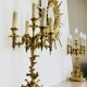 Massive gilded bronze chandeliers from the mid-20th century with marble bases.
