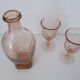 Old bottle in pink glass and 2 wine glasses