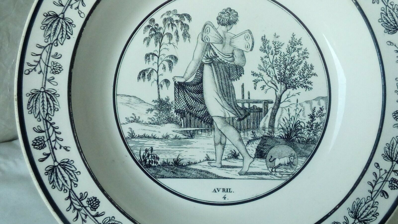 CHOISY HOLLOW PLATE IN FINE FAIENCE ON THE THEME OF THE MONTHS "APRIL"
