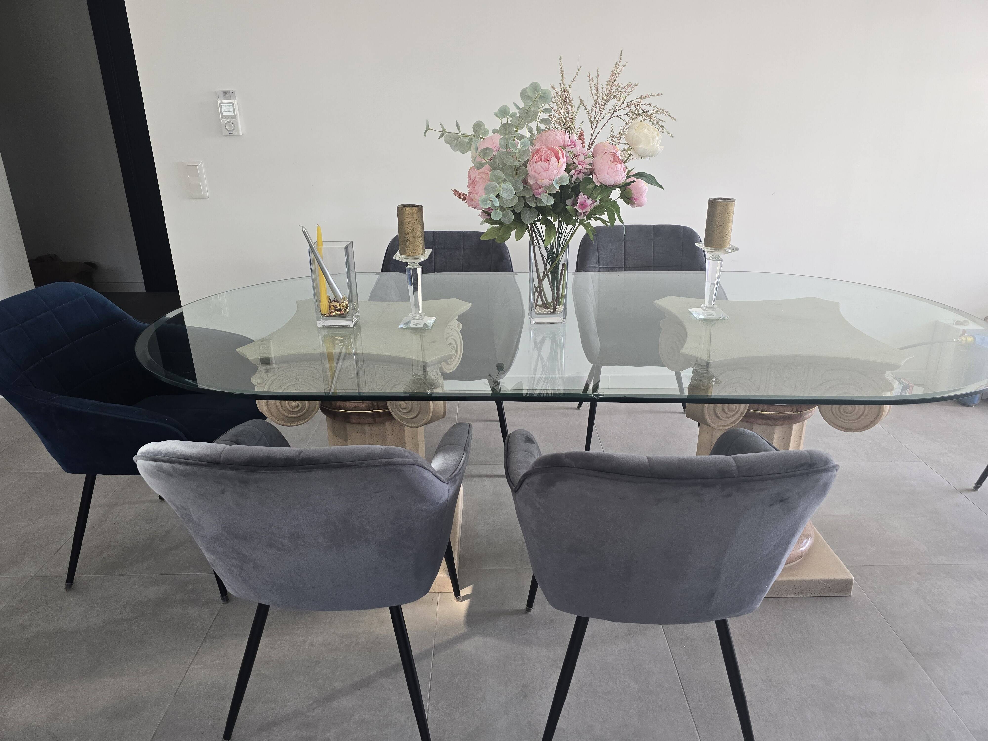 Oval glass table with marble column.