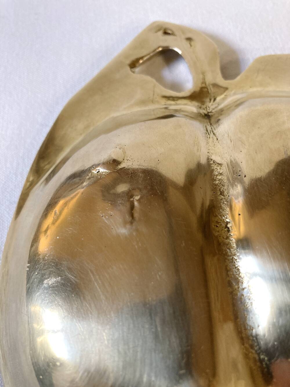 Brass catchall in the shape of an apple.