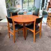 4 Scandinavian chairs in teak and black faux leather.