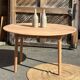 Large round family table with 2 extensions in solid raw wood.