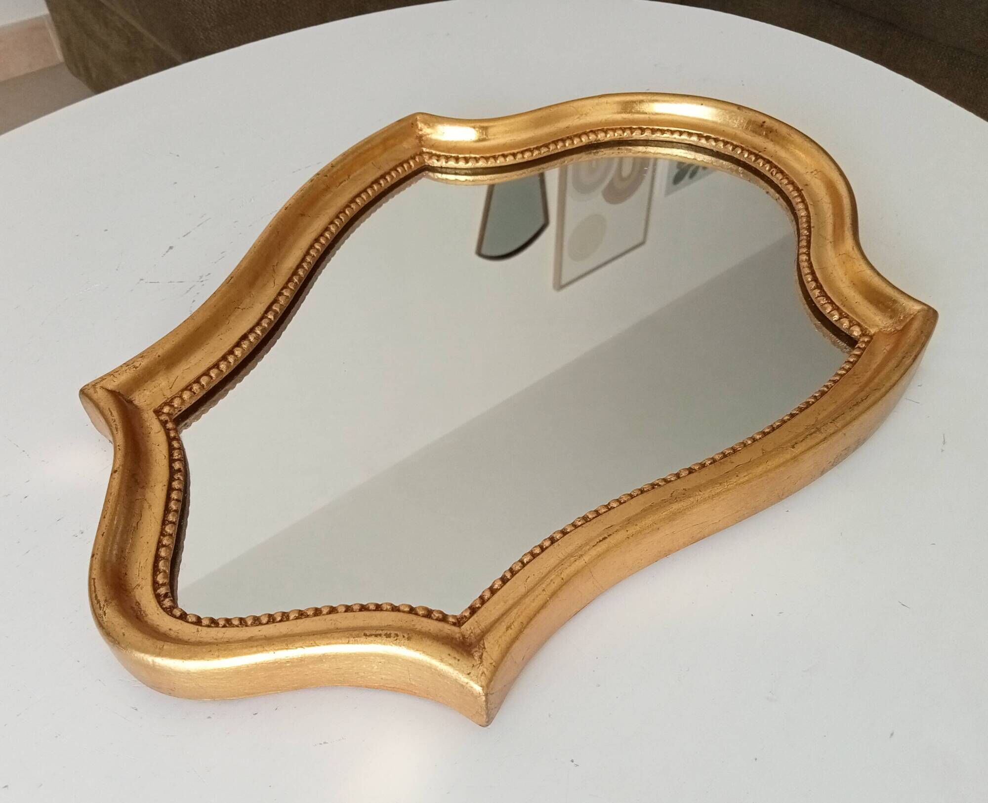 Vintage baroque mirror in gilded wood in the Louis XV style.