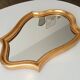Vintage baroque mirror in gilded wood in the Louis XV style.