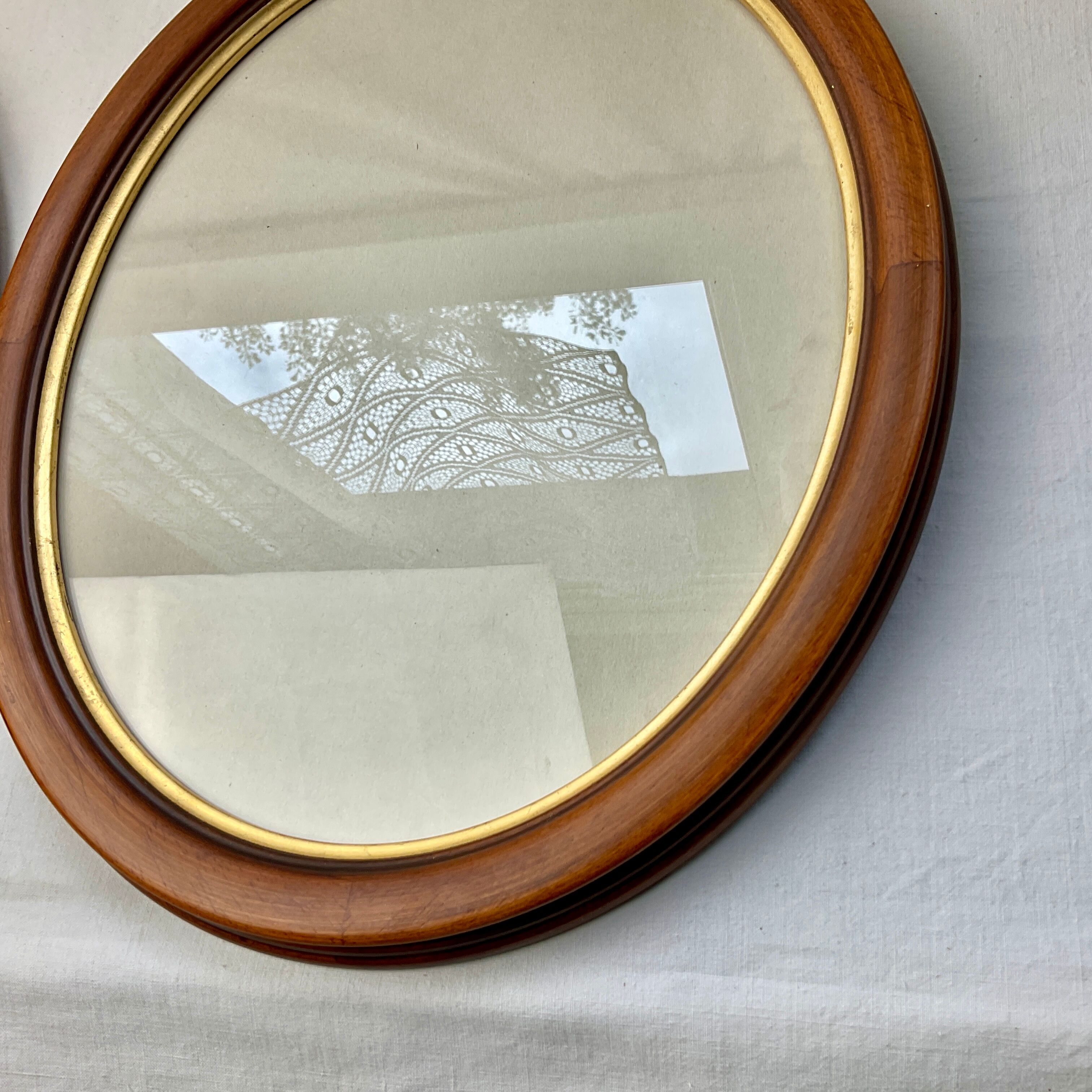 Pair of oval wooden frames with gilding