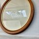 Pair of oval wooden frames with gilding