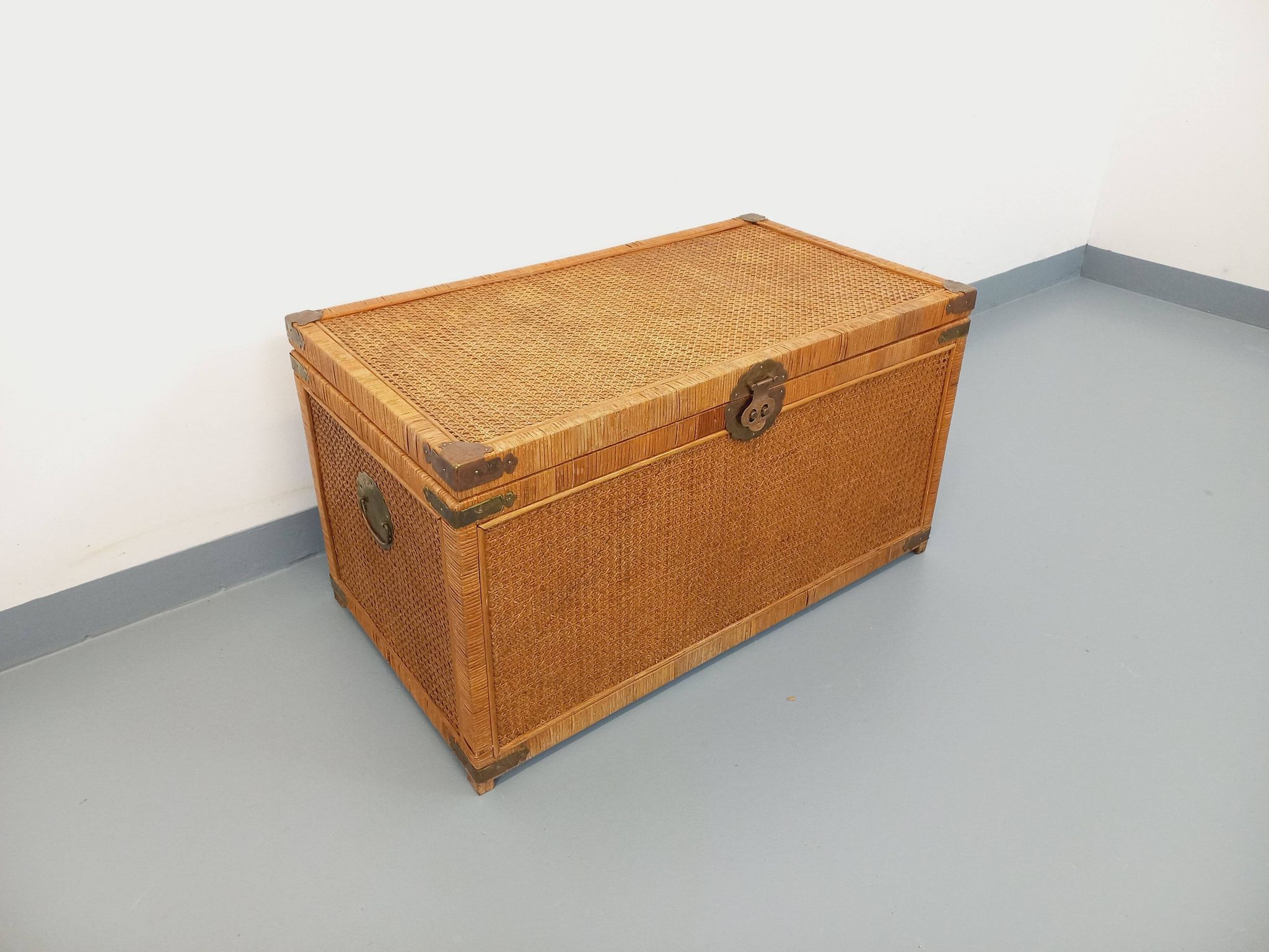 Vintage trunk in wood, rattan, caning, and brass.