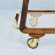 May include: A mid-century modern bar cart with a dark wood frame and two c