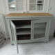 Vintage buffet on grey green wheels, 2 glass doors, wooden tray.