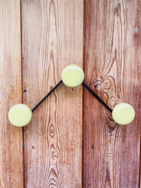 Vintage yellow wall coat rack