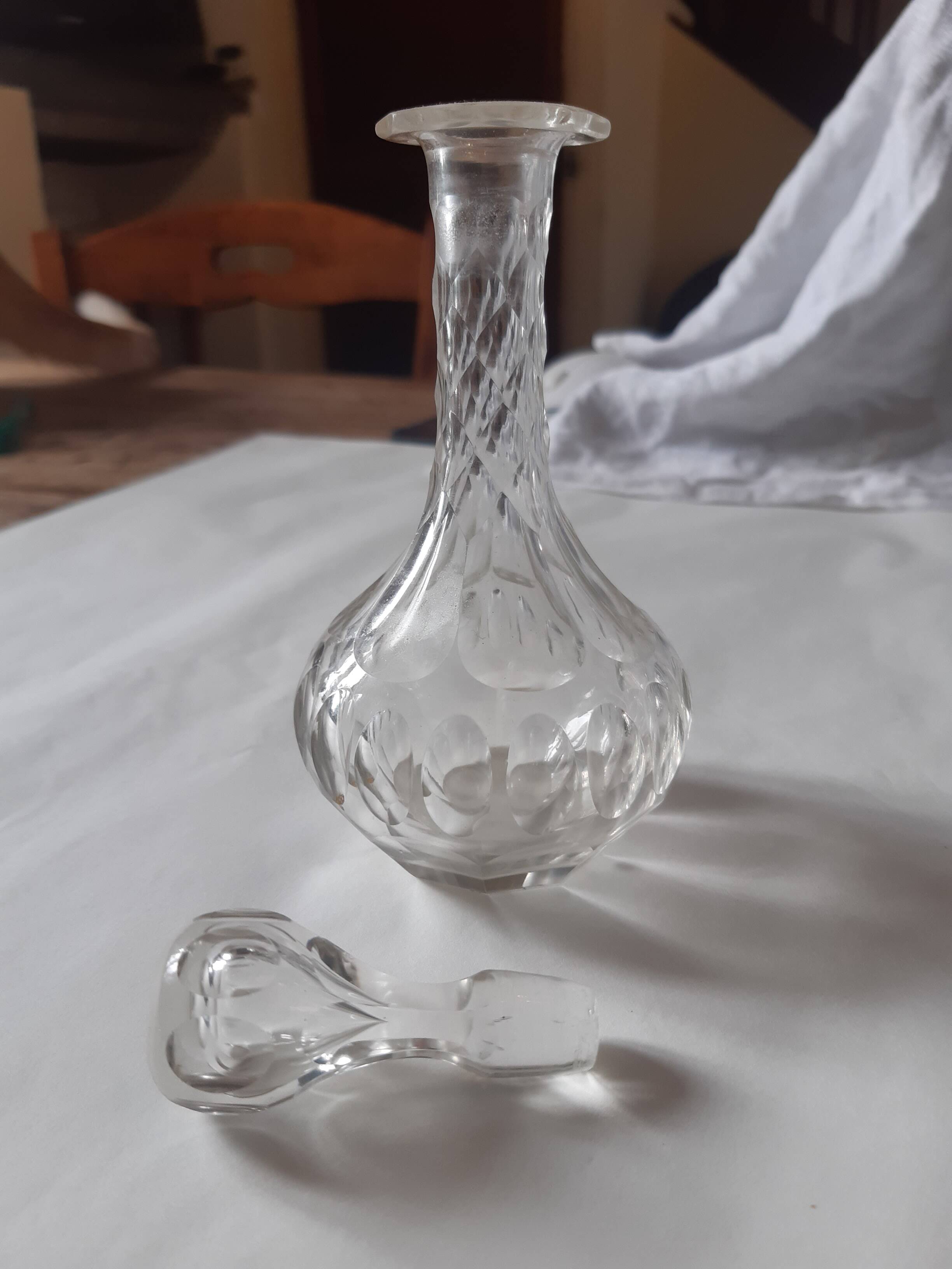 Cut crystal oil bottle with its crystal stopper.