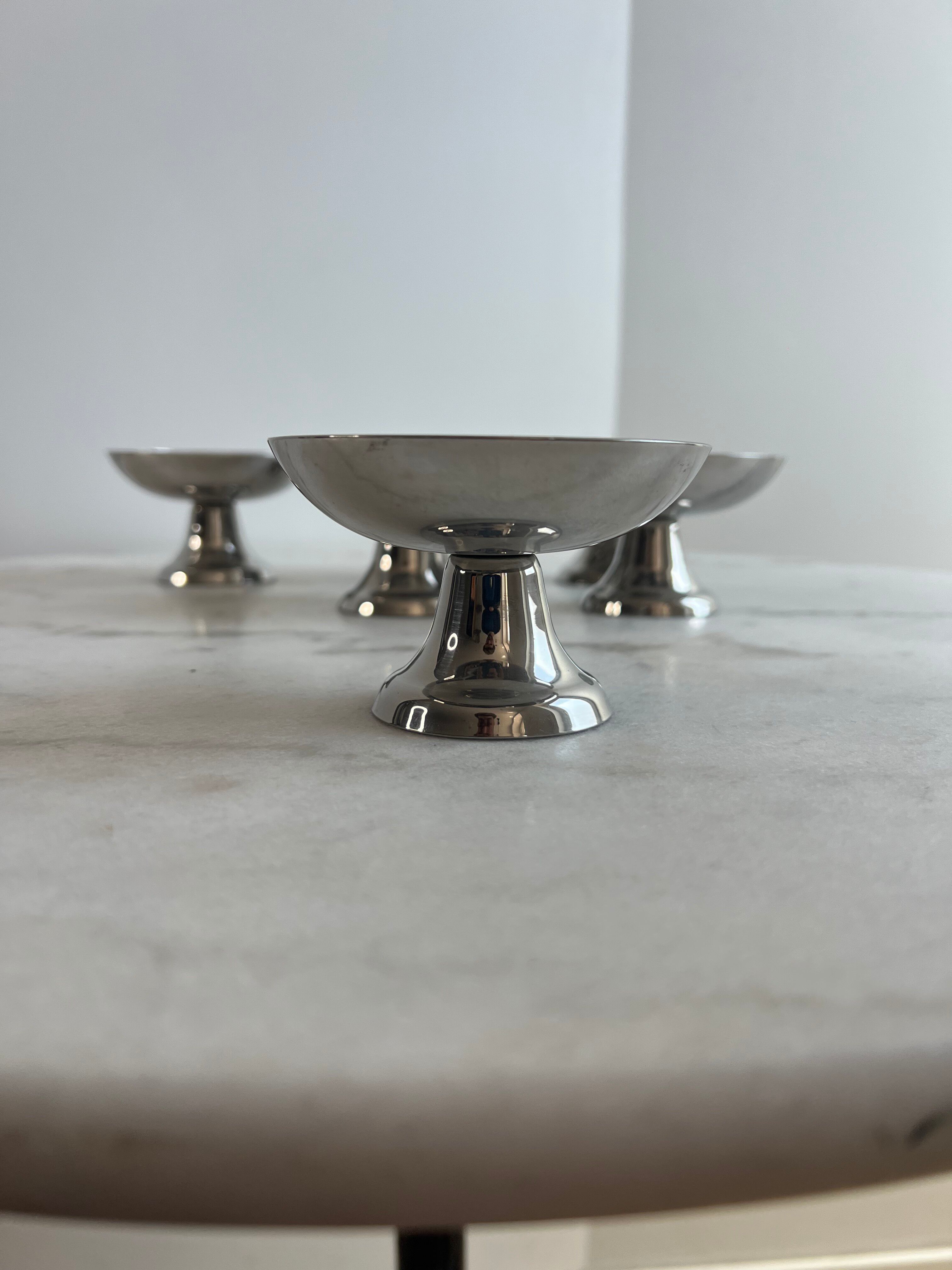 Set of 6 stainless steel dessert bowls on a stand.