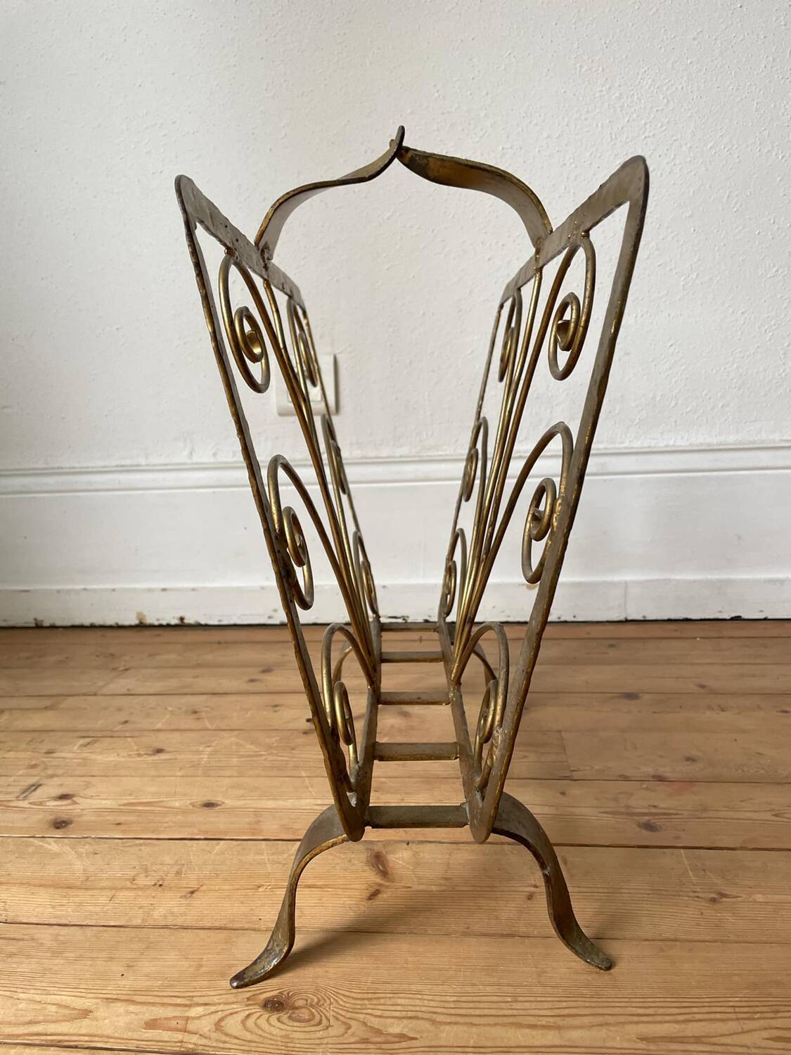 Vintage wrought iron magazine rack with gold butterfly design
