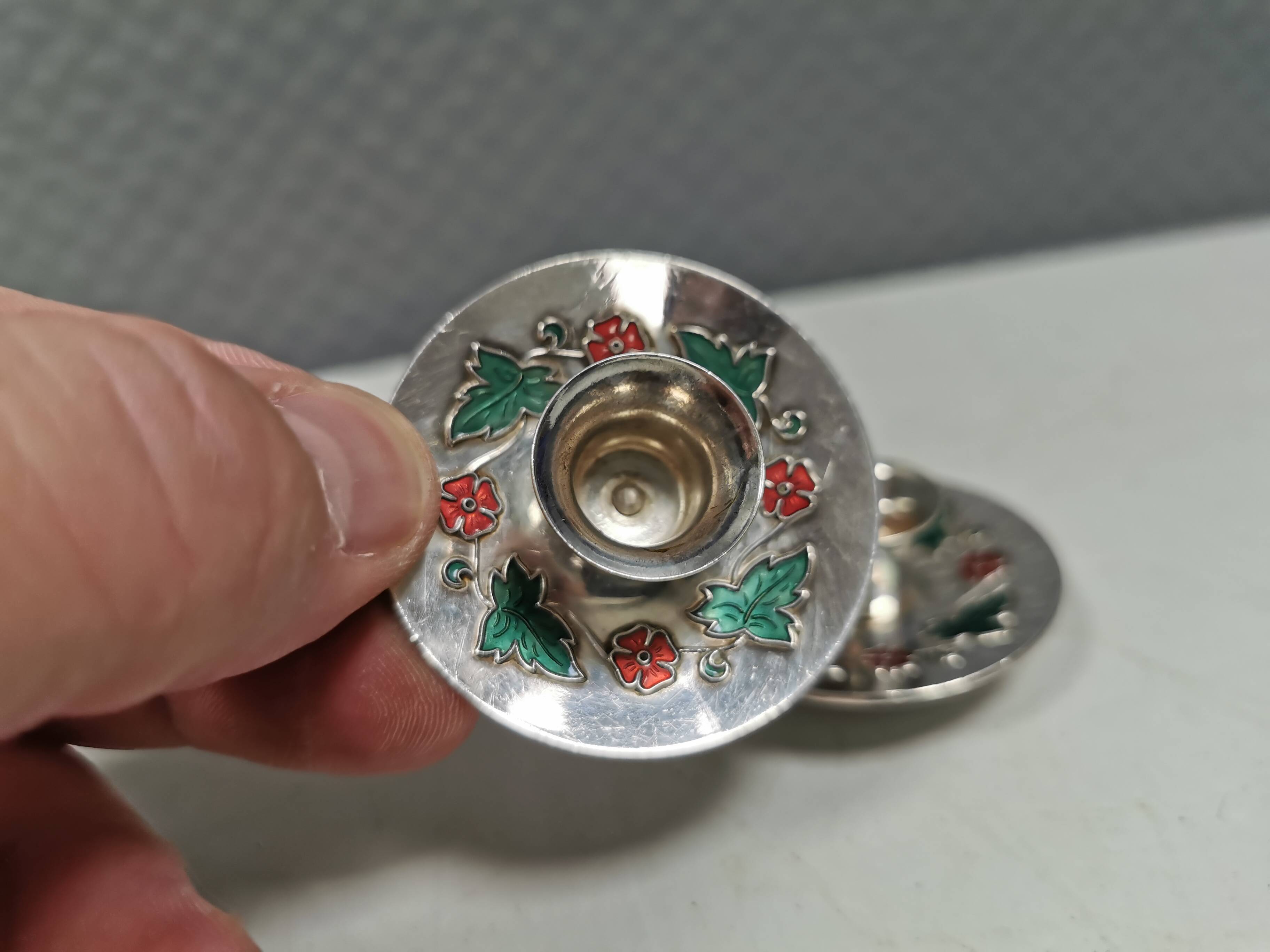 Silver-plated candle holders with inlaid red and green enamel