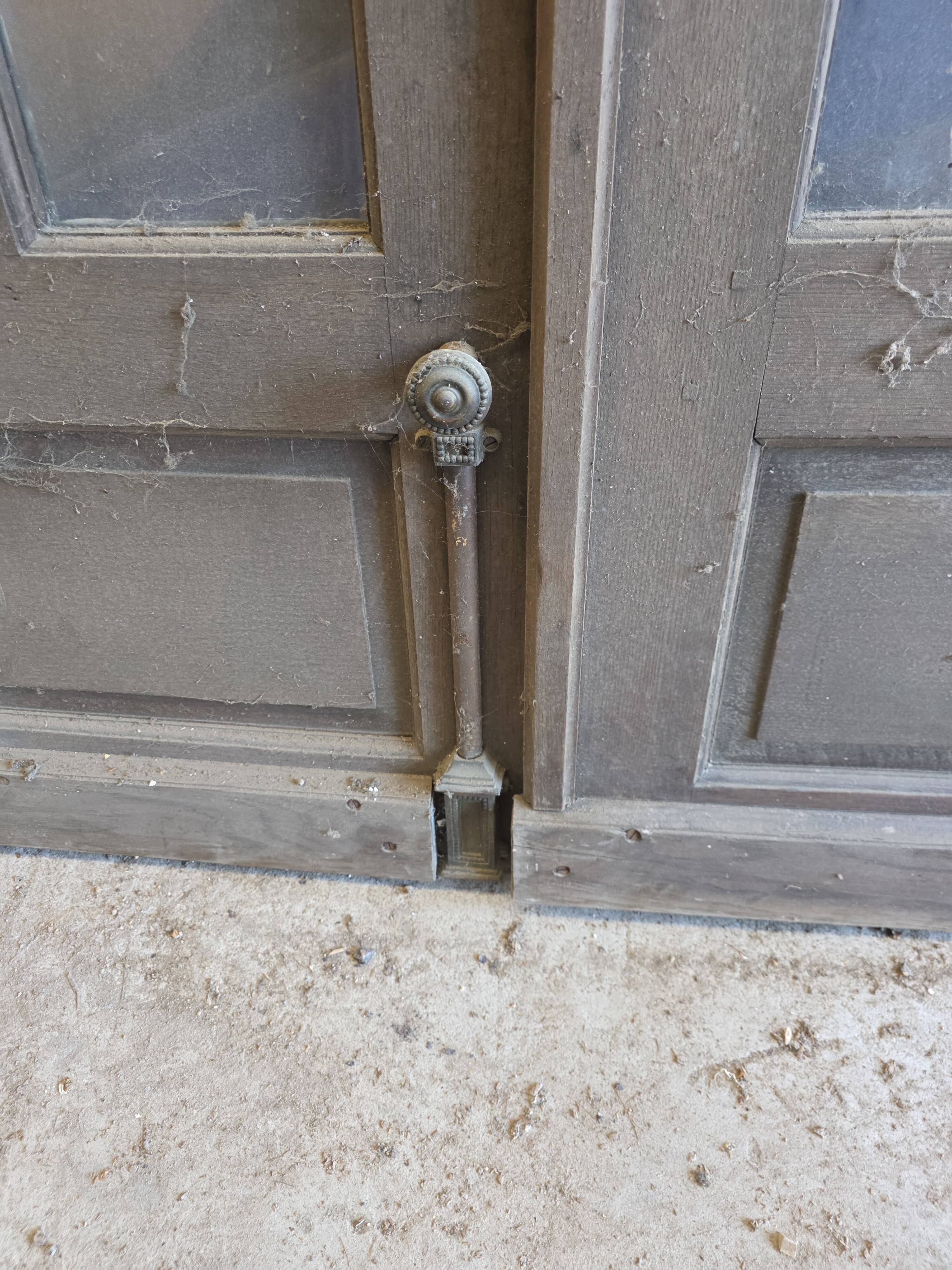 Two pairs of solid oak doors with small panes.