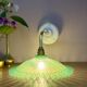 Green vintage plastic wall lamp with a curved arm