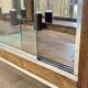 Early 20th-century shop display cabinet in oak with sliding doors.