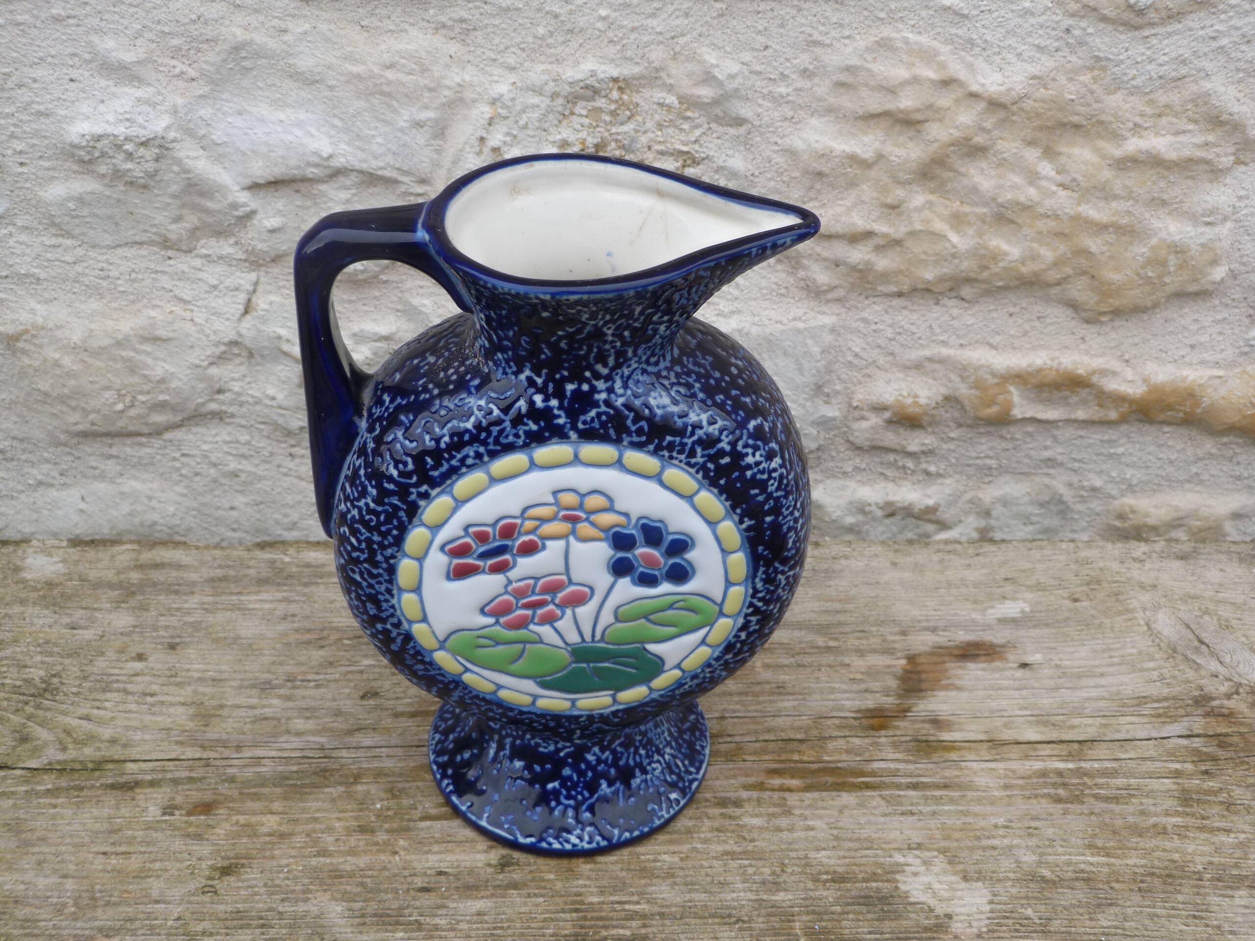 Blue ceramic vase with floral motifs