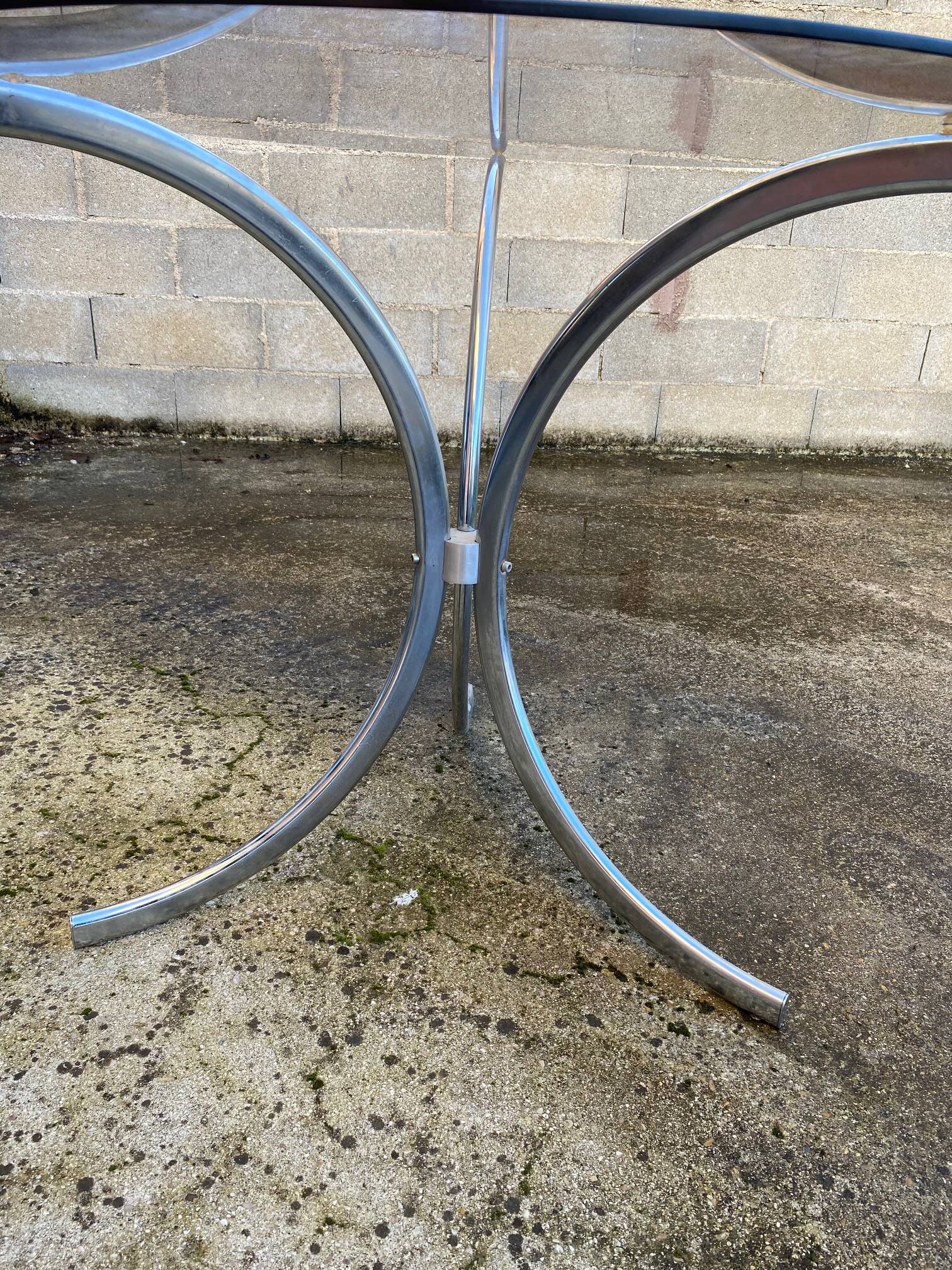 Table with chrome metal legs and smoked glass top.
