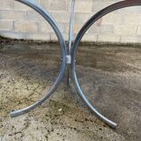 Table with chrome metal legs and smoked glass top.