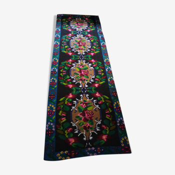 Romanian floral runner rug on blue background