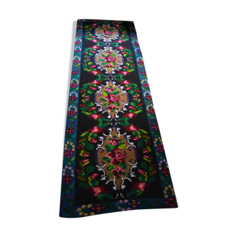 Romanian floral runner rug on blue background