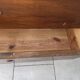 Antique solid wood chest of drawers with a white marble top.