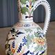 Polychrome earthenware jug, hand-decorated with floral motifs