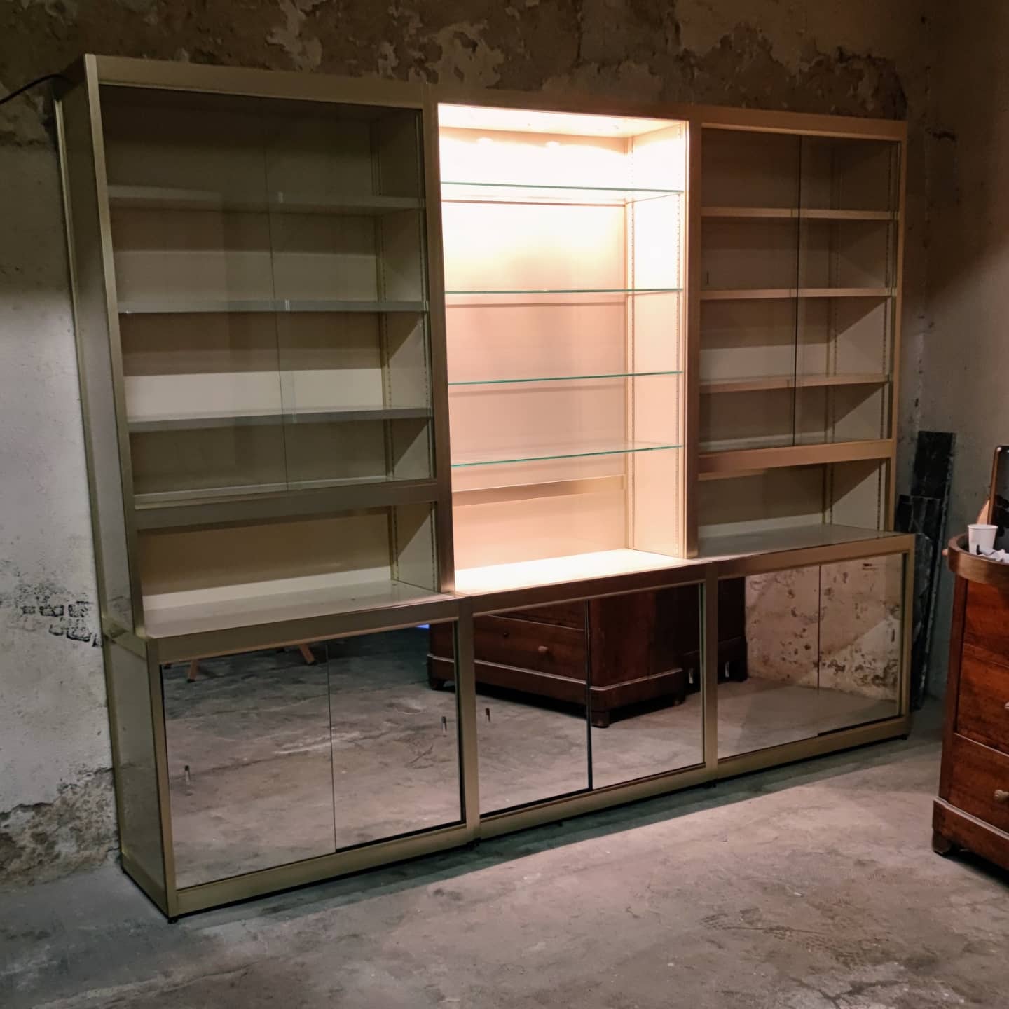 Ivory-colored and matte gold anodized aluminum display bookcase