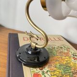 Swan neck wall light in brass with glass tulip.