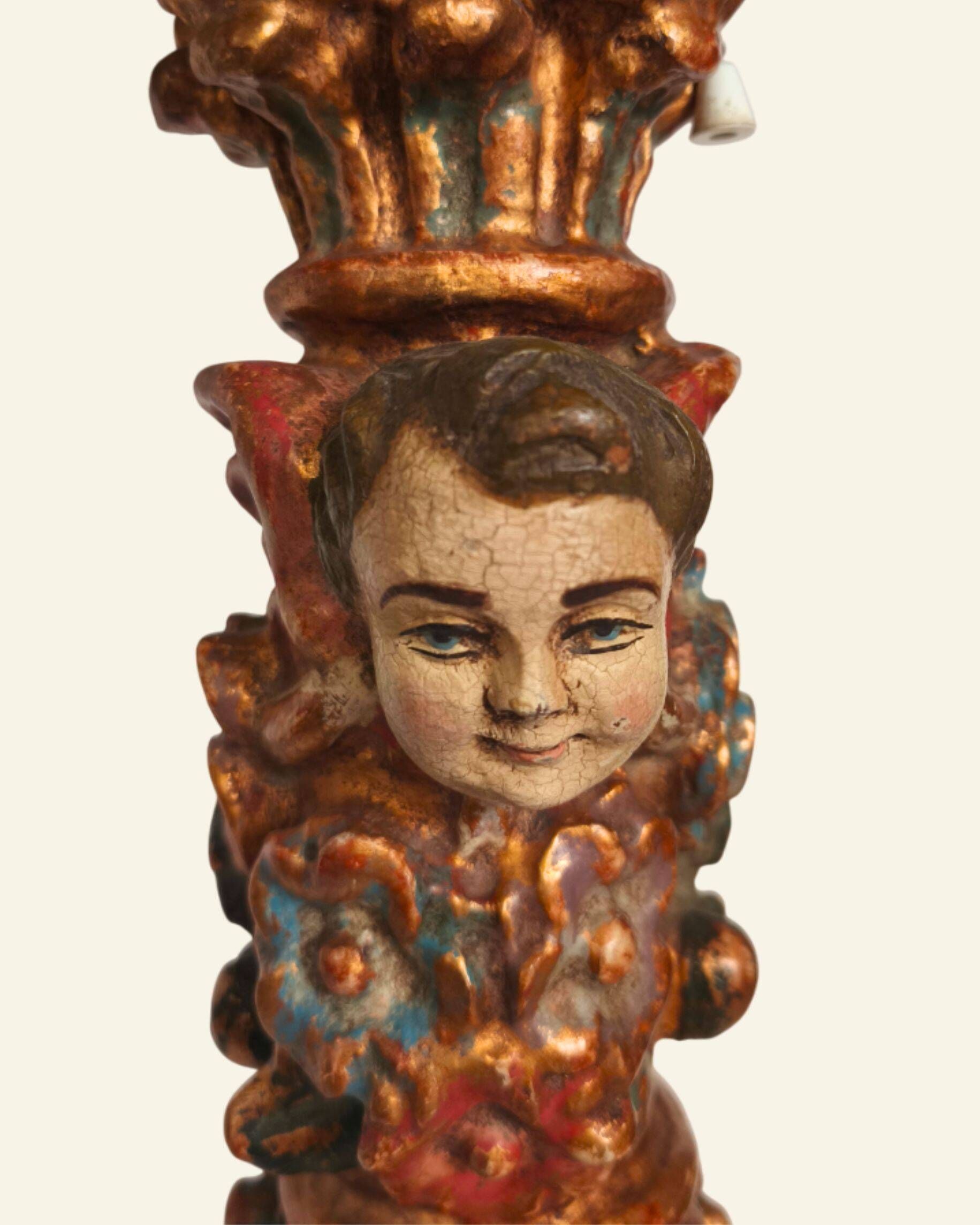 Renaissance table lamp in polychrome carved wood with cherubs.
