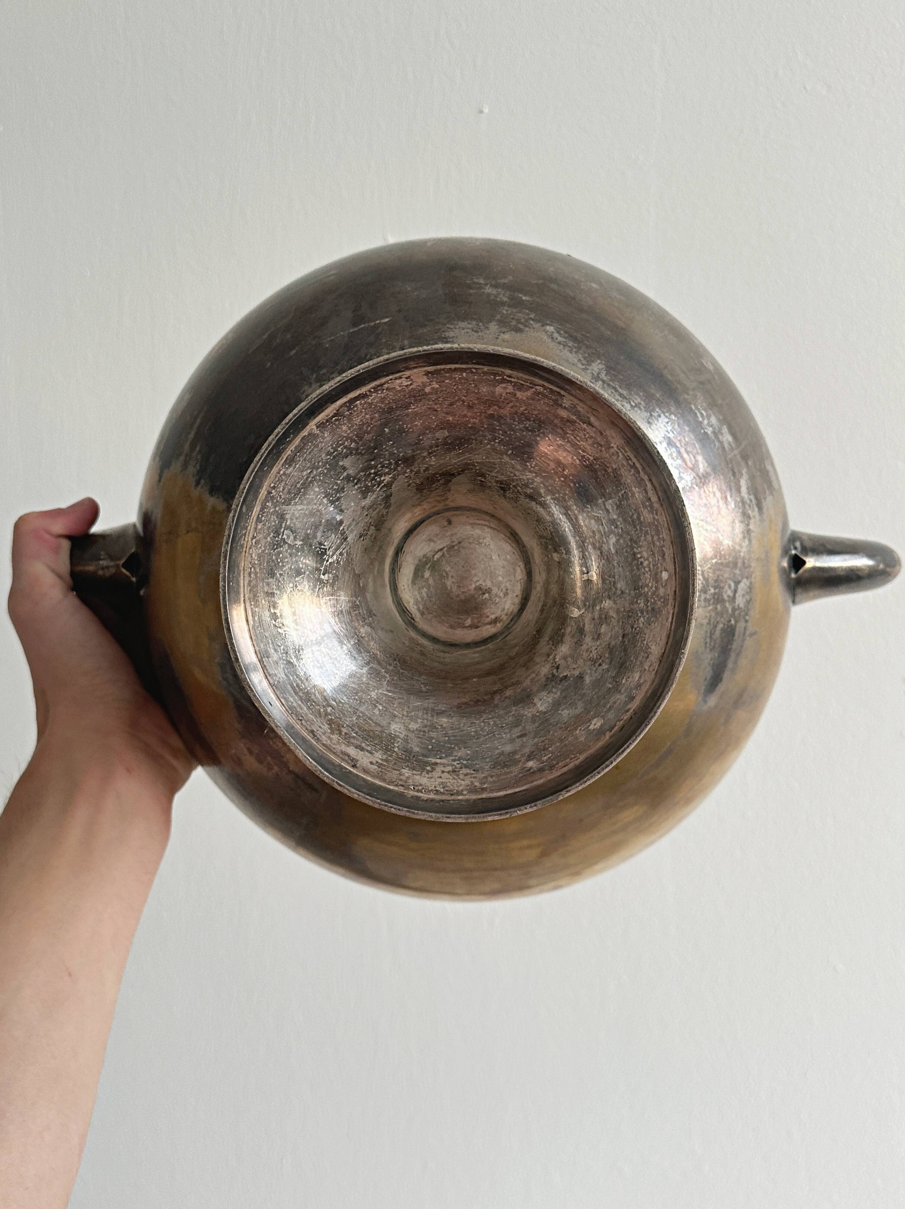 Large champagne bucket with patinated metal swan handles.