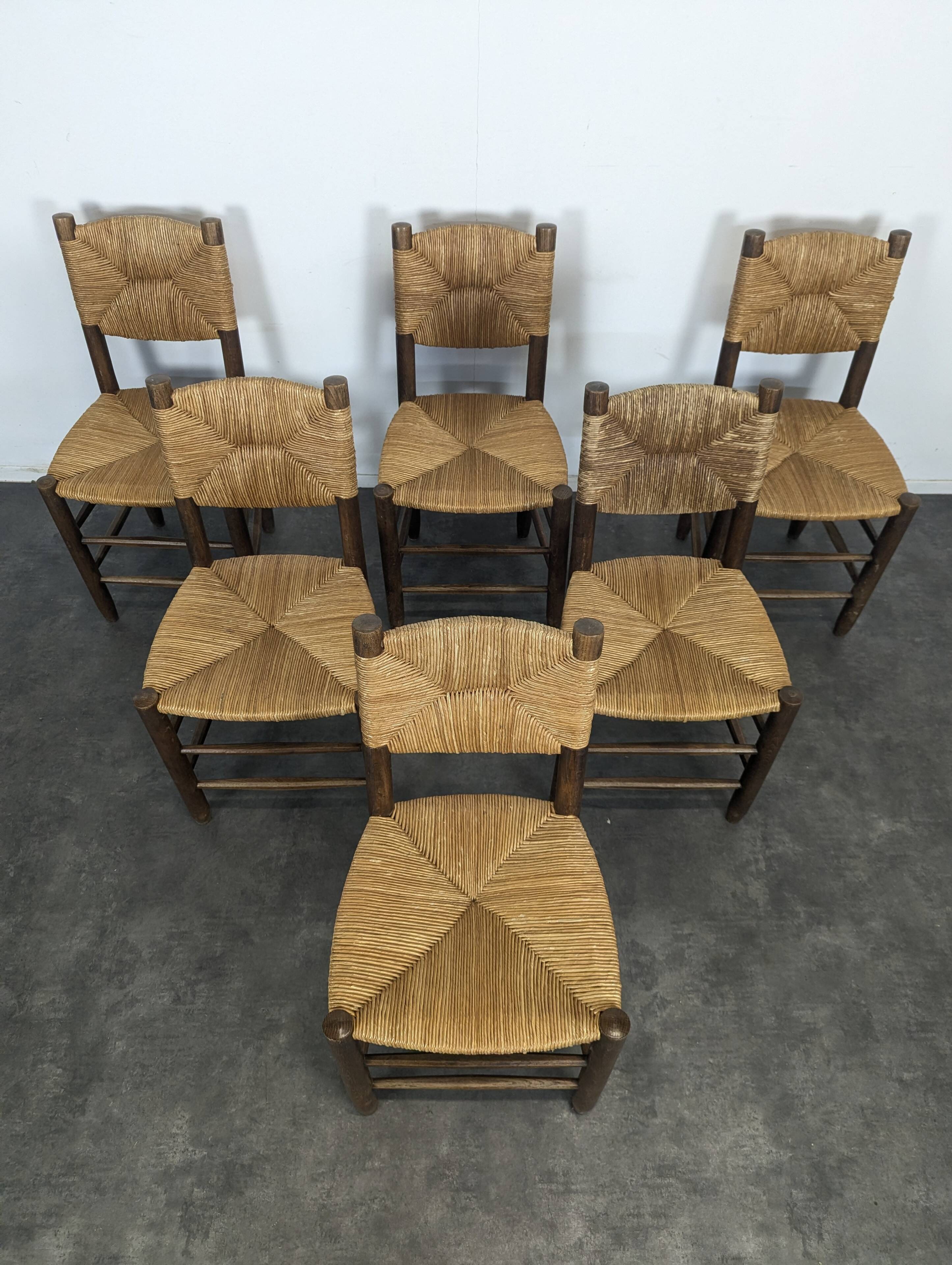 Série de 10 chaises modèle Bauche par Charlotte Perriand, circa 1960