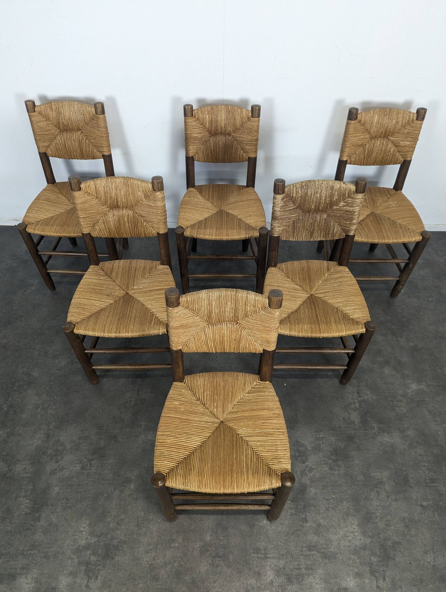 Set of 10 Bauche model chairs by Charlotte Perriand, circa 1960.