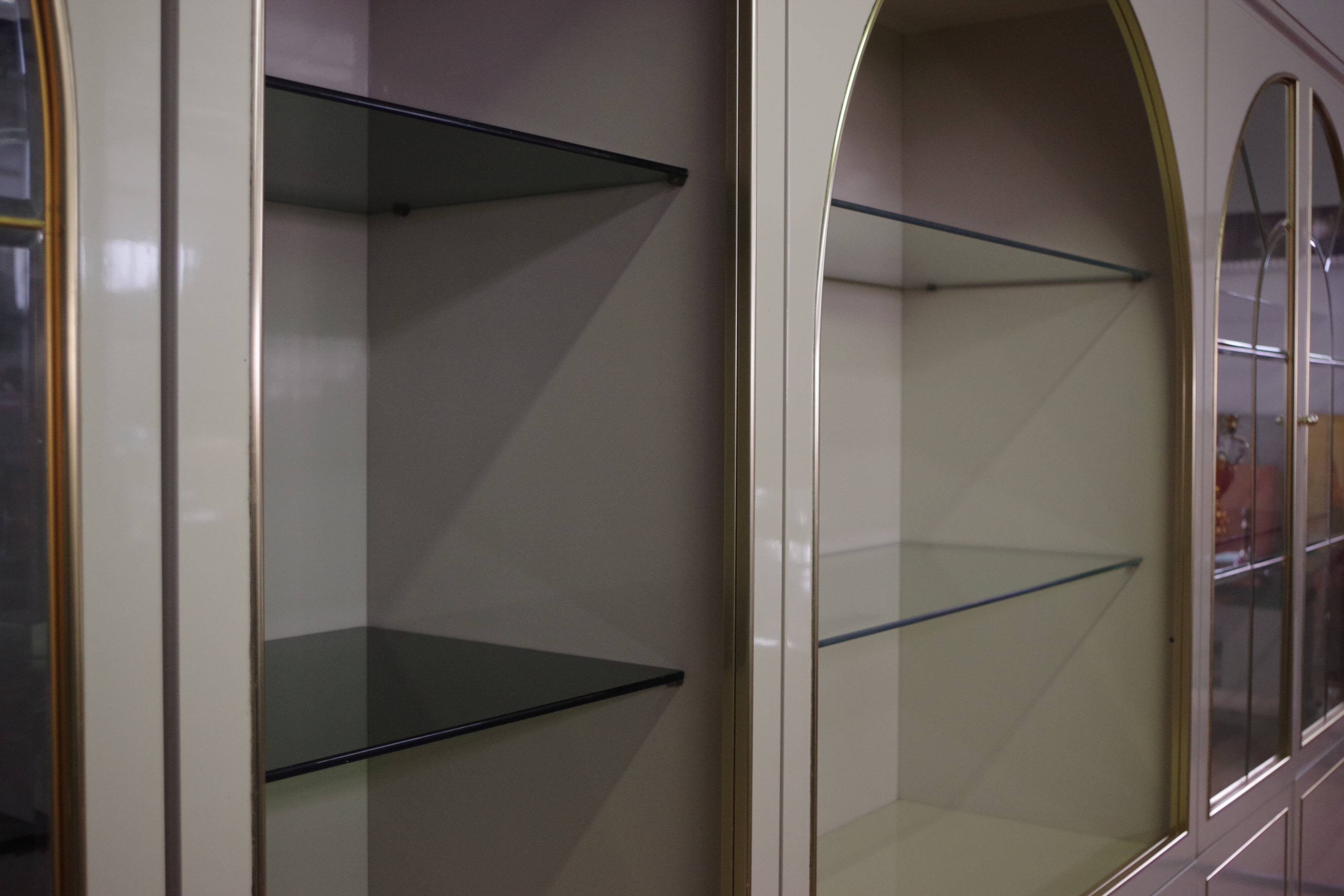 Showcases in lacquered wood, glass and brass  1970s, set of 4