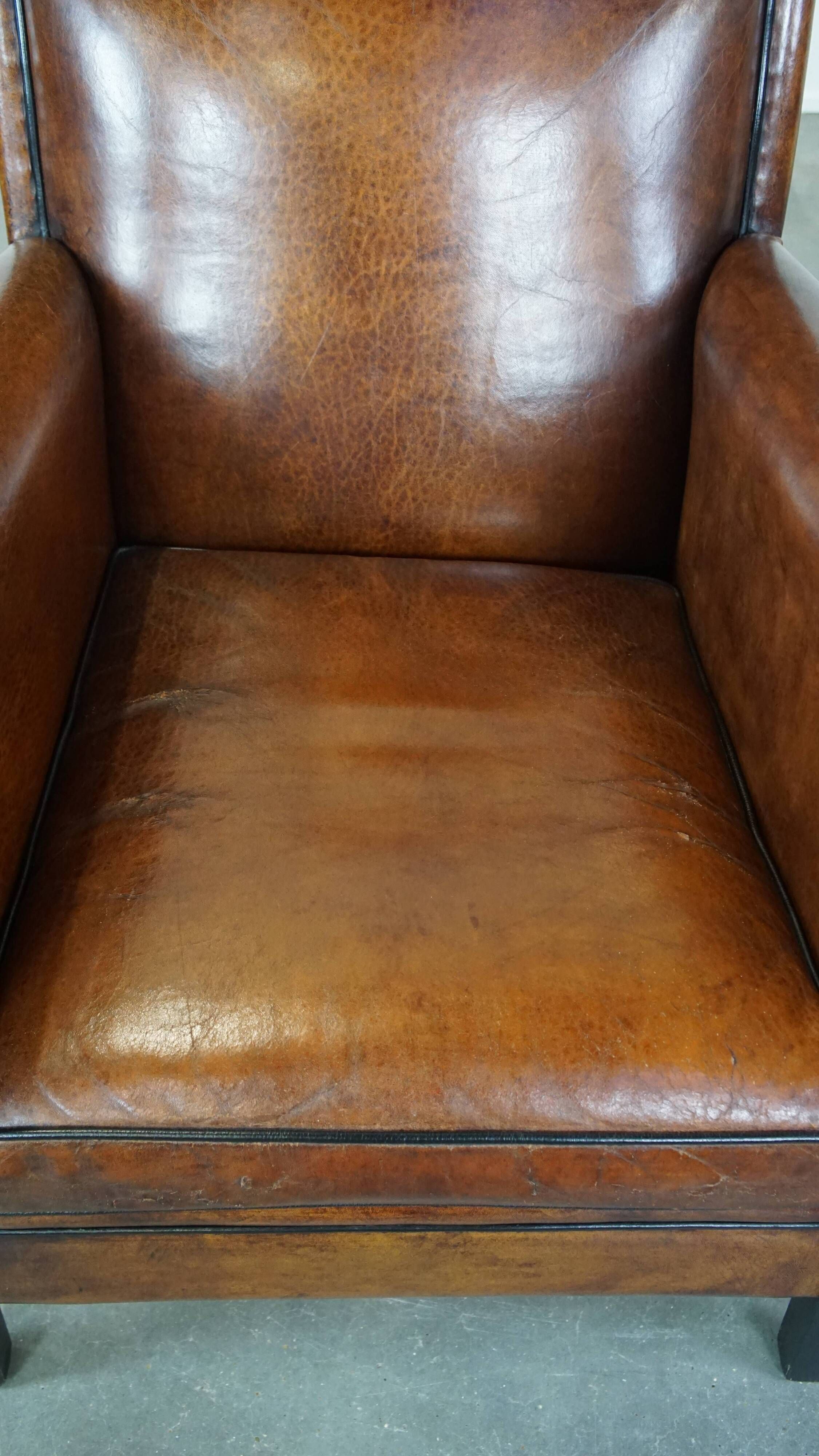 Cognac-colored sheep leather Art Deco design armchair finished with piping