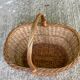 Round woven wicker basket with handle