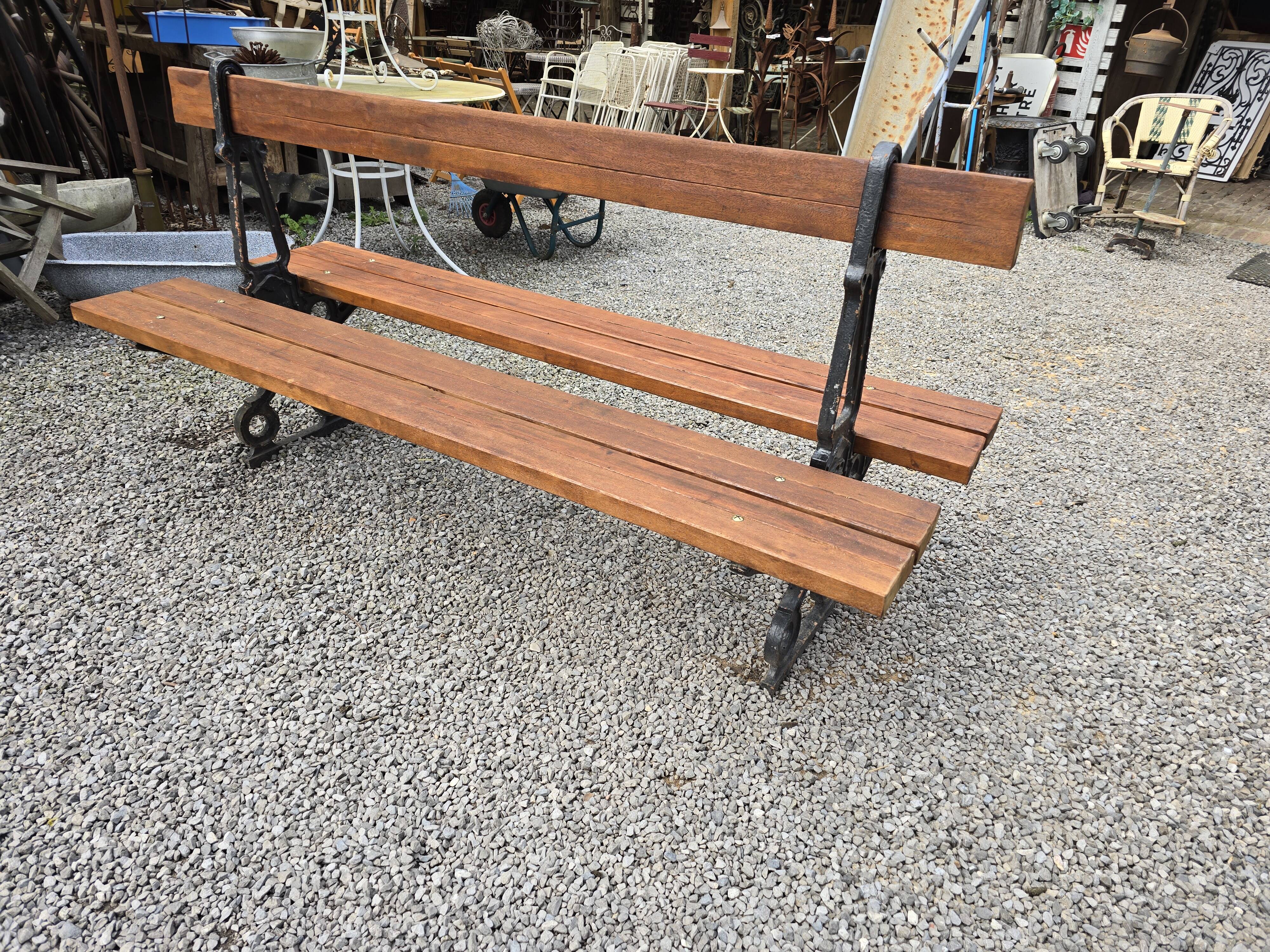Antique double garden bench from the city of Paris in cast iron and wood