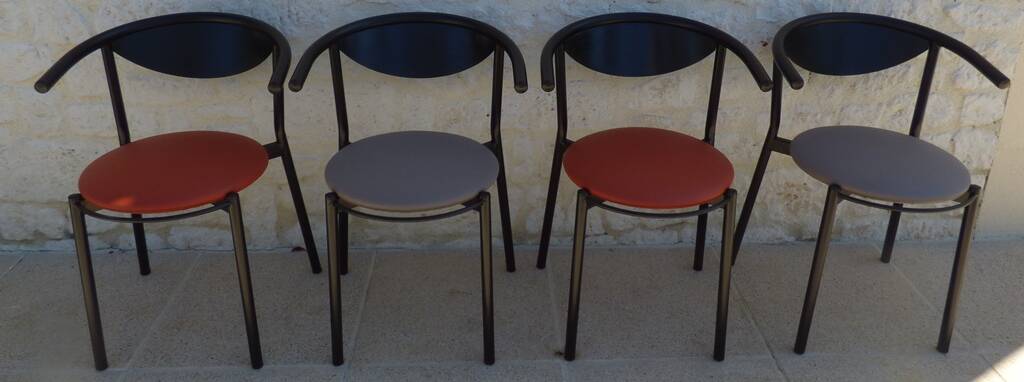 4 gondola-style chairs with a sturdy metal frame and faux leather.