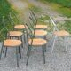 Set of 7 metal chairs by René Herbst with wooden seats.
