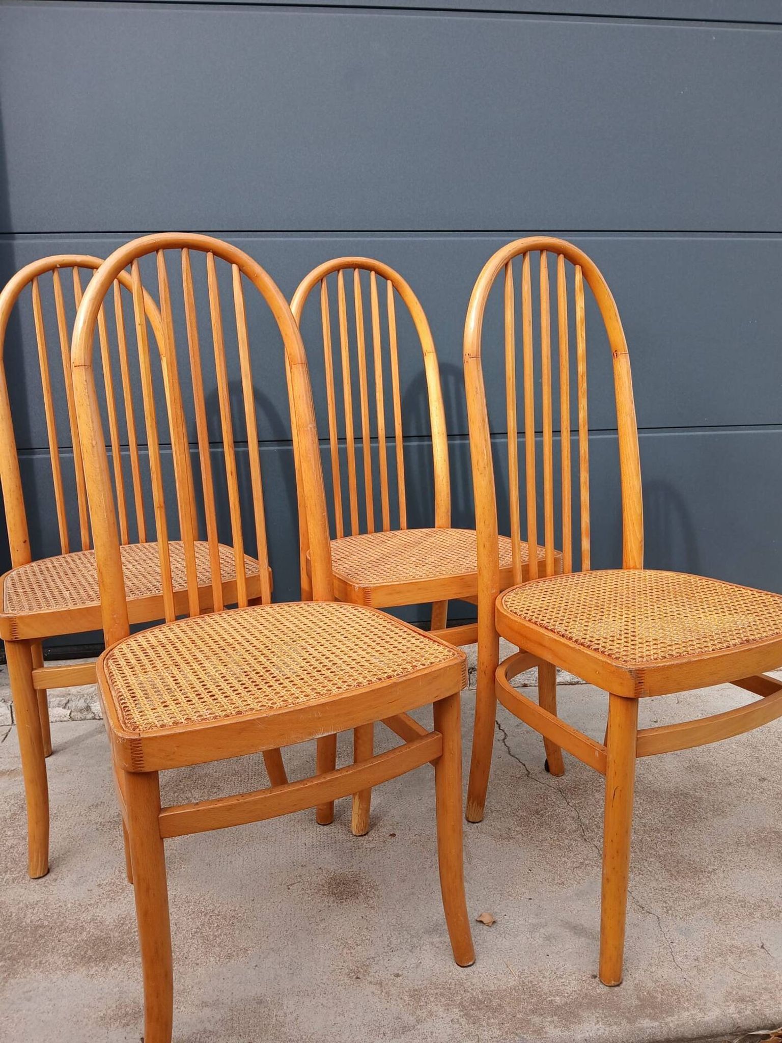 Set of 4 vintage Baumann chairs in honey wood and cane.