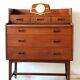 Mid-century teak dressing table in curved brown with sliding mirror and 6 drawers.