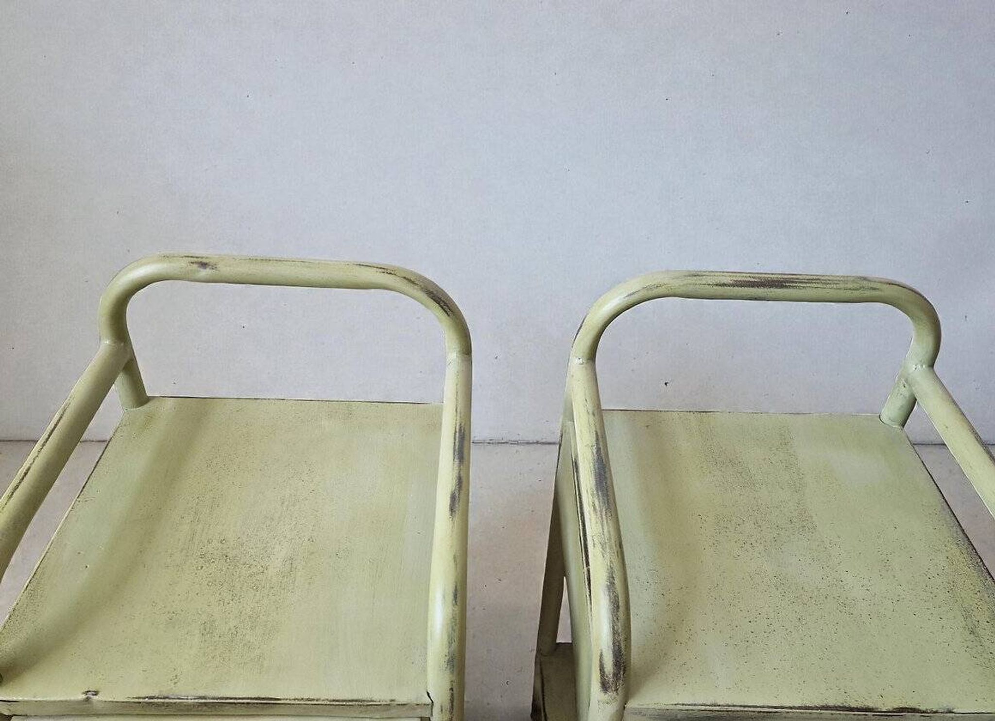 Copy of a pair of patinated metal bedside tables.