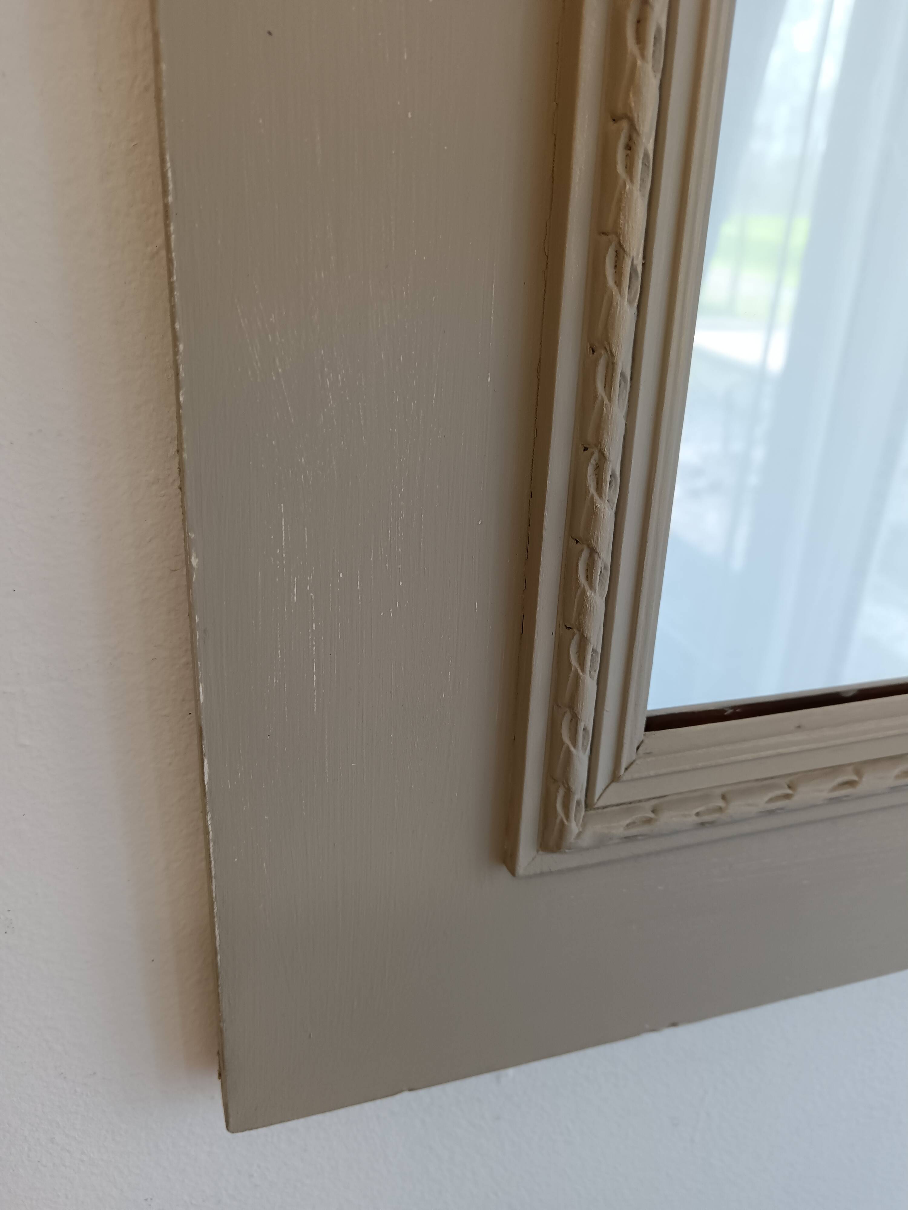 Wooden mirror with patinated beige knot