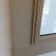 Wooden mirror with patinated beige knot