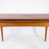 Dining table in teak with extentions and legs in oak, of danish design from the 1960s.
