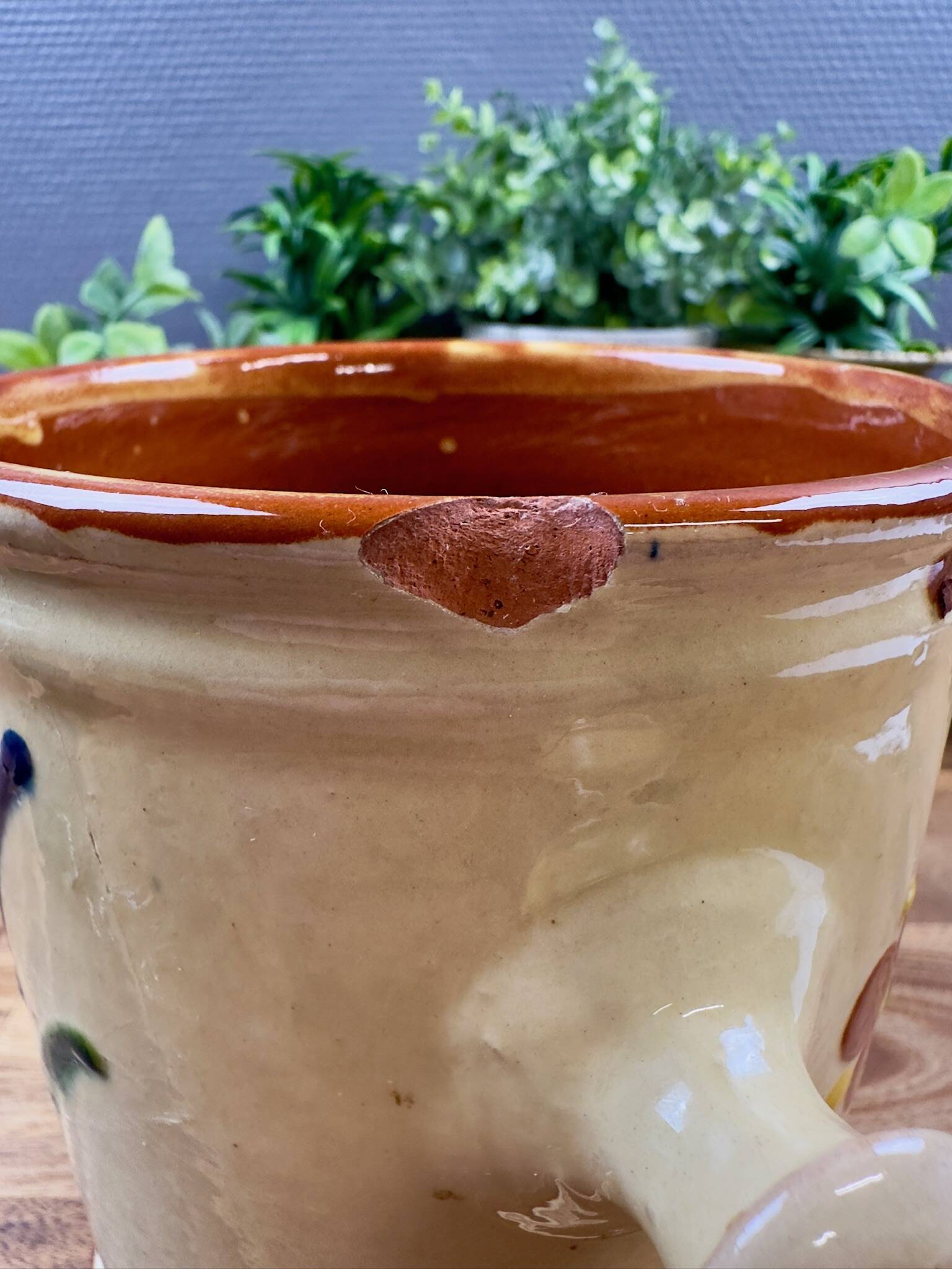Antique ceramic pot with hand-painted floral decoration.