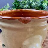 Antique ceramic pot with hand-painted floral decoration.