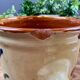 Antique ceramic pot with hand-painted floral decoration.